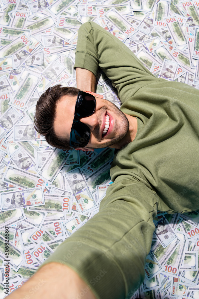 Sticker vertical above view portrait of positive successful man make selfie isolated on usd money ocean back