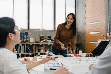 Multiracial group of young creative people in casual wear meeting brainstorming ideas about new paperwork project colleagues working together planning success strategy enjoy teamwork in small office