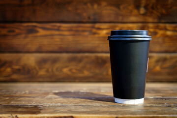 Coffee paper cup on wooden table background. Drink coffee take away mockup. 