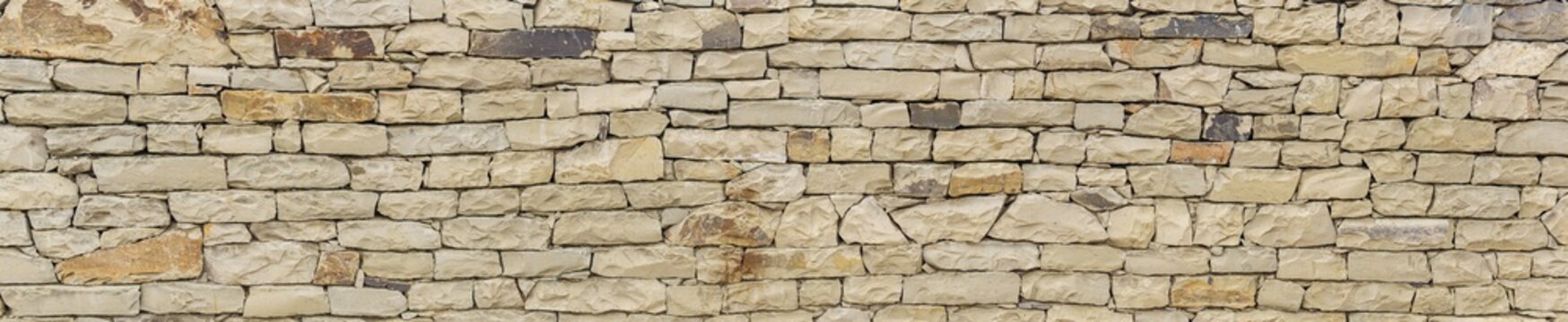 horizontal background, texture - wall of roughly hewn natural light stone