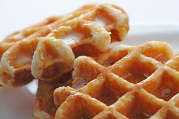 Two waffles with syrup