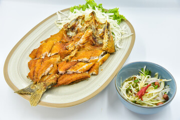 Deep-fried Seabass with Fish Sauce - Thai food, top view on white background.