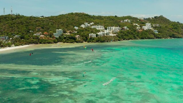 Kitesurfers enjoying wind power on Bulabog beach, top view. Kitesurfing on a tropical island. Boracay, Philippines