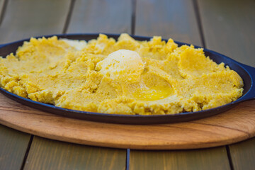Traditional Montenegrin Meal. Kacamak in a black pan