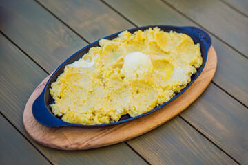 Traditional Montenegrin Meal. Kacamak in a black pan