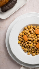 Cooked chickpeas with carrot, blood sausage and chorizo