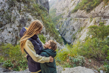 Mom and son tourists in the background of Beautiful Canyon of Moraca river in winter, Montenegro or Crna Gora, Balkan, Europe