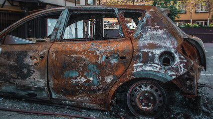 Irpin, Kyiv Oblast,  Ukraine - 19.05.2022: Cities of Ukraine after the Russian occupation. burnt civilian car in  city of Irpin, northwest of Kyiv