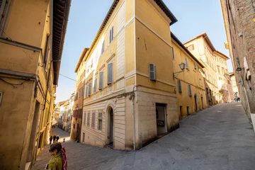 Fototapete Rund View on narrow and cozy street in the old town of Siena city in Italy. Concept of ancient architecture of the Tuscan region © rh2010