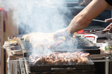 Food festival photography. Outdoor cooking in the park. Grilled corn. Grilled meat. Hot on the photo. 