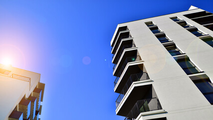 Obraz premium Apartment residential house and home facade architecture and outdoor facilities. Blue sky on the background. Sunlight in sunrise.