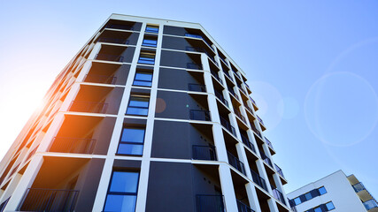 Apartment residential house and home facade architecture and outdoor facilities. Blue sky on the background. Sunlight in sunrise.