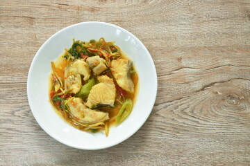 spicy fried Asian redtail catfish with herb and chili on plate