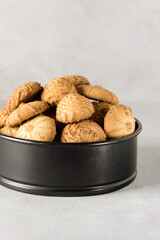 Tasty butter cookies in a tin on gray background Set of crispy shortbread biscuits in an open container Baked pastry, breakfast sweet food Vertical