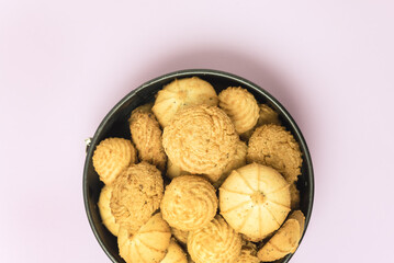 Tasty butter cookies in a tin on pink background Set of crispy shortbread biscuits in an open container Baked pastry, breakfast sweet food