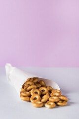 Heap small sushki on a blue and pink background Russian or Ukrainian traditional food of sweet wheat dough Vertical