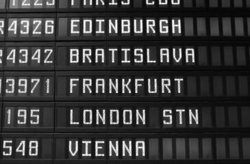 Flights in Europe - airport timetable. Black and white vintage style photo.