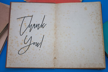 Thank You word in opened book with vintage, natural patterns old antique paper design.