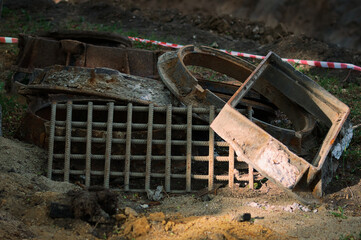 A pile of scrap metal. Rusty metal structures lie in a pile on a construction site. Reconstruction of the sewerage system.