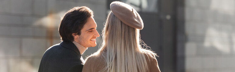 blonde woman in beret near young and happy man outdoors, banner. - obrazy, fototapety, plakaty