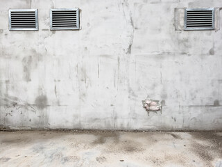 Worn cement wall with ventilation exhaust grills as urban background