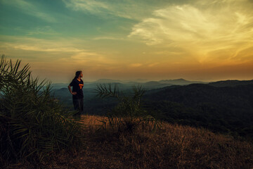 silhouette of a person walking on a hill