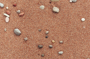 Fototapeta na wymiar beach with yellow sand close-up, beautiful stones in the frame