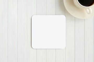 White blank square coaster mockup for design presentation on white wooden table. - obrazy, fototapety, plakaty