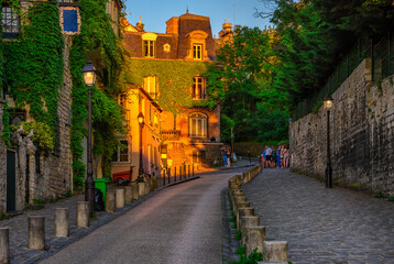 Sunset view of cozy street in quarter Montmartre in Paris, France. Architecture and landmark of...