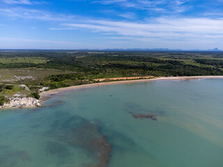 Amazing paradisiacal and deserted beach with clear blue waters and visible corals at low tide - Cumuruxatiba, Bahia, Brazil - aerial drone view