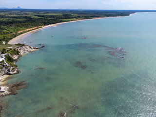 Amazing paradisiacal and deserted beach with clear blue waters and visible corals at low tide - Cumuruxatiba, Bahia, Brazil - aerial drone view