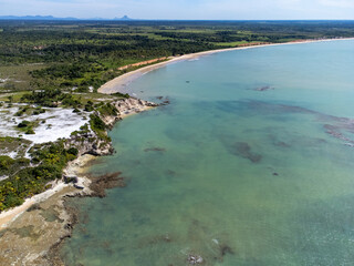 Fototapeta na wymiar Amazing paradisiacal and deserted beach with clear blue waters and visible corals at low tide - Cumuruxatiba, Bahia, Brazil - aerial drone view