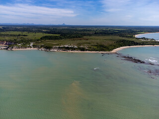 Amazing paradisiacal and deserted beach with clear blue waters and visible corals at low tide - Cumuruxatiba, Bahia, Brazil - aerial drone view