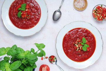 Plates with traditional gazpacho tomato soup