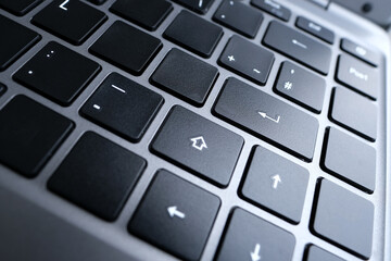 close-up part of a laptop, black keyboard of a laptop computer, buttons, concept of technology, working, learning from home in digital age, full-time teleworking