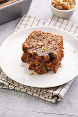 Slices of Chocolate banana bread with walnuts on a checkered kitchen napkin and ingredients on a grey neutral background