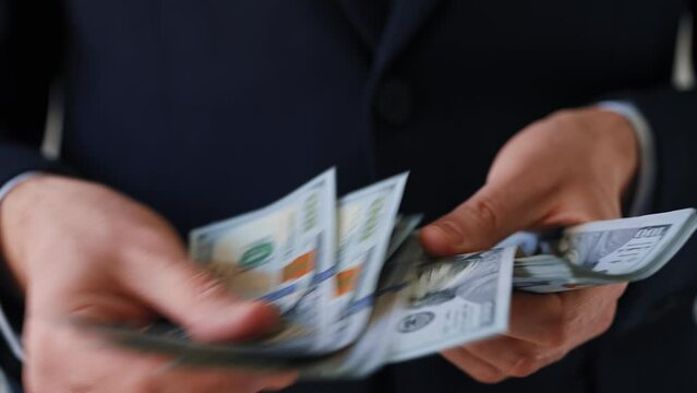 Formally dressed man counting US Dollar bills. Concept of investment, success, financial prospects or career advancement