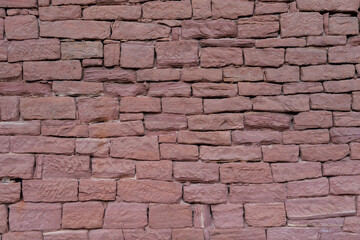 beautiful vintage texture of the wall of a medieval castle built in the middle of the 17th century, multi-colored volumetric stones for the designer, wallpaper, background