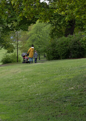 mother with two children walking in the park