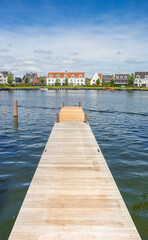 Fototapeta na wymiar Wooden jetty and white houses in Harderwijk, Netherlands