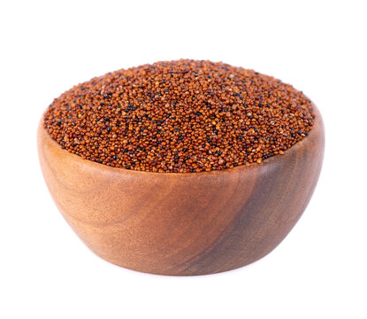 Canihua grains isolated on white background. Pile of qaniwa in wooden bowl. Dry grains of chenopodium pallidicaule.
