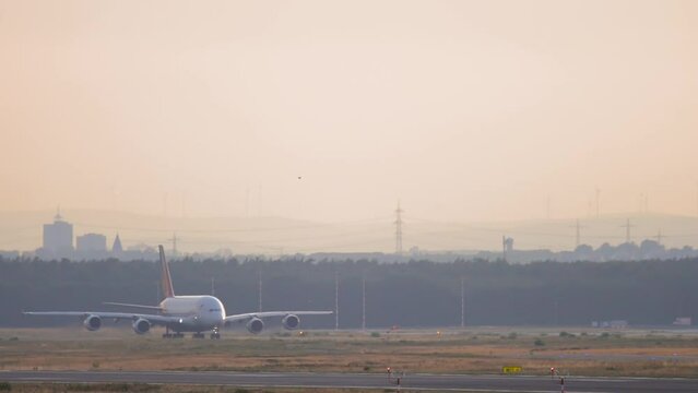 Long shot of a huge double-deck passenger plane on the runway of the airfield. Tourism and travel concept
