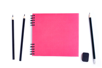 Pink notebook, Black pencils and black eraser isolated on white background