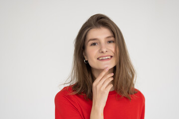 Fototapeta premium Candid portrait of young beautiful woman smiling happy at camera on white background.