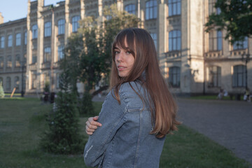Fototapeta premium Young cute girl walking in city park