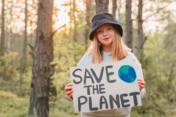 happy smiling teen looking to camera holding a colorful save planet ecology poster. a school girl...