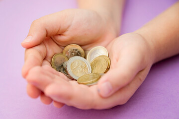 Euro coins in kids hands. Currency transfer, investment, payment, donation, gift concept. Saving money for the future, education, car, weddings.