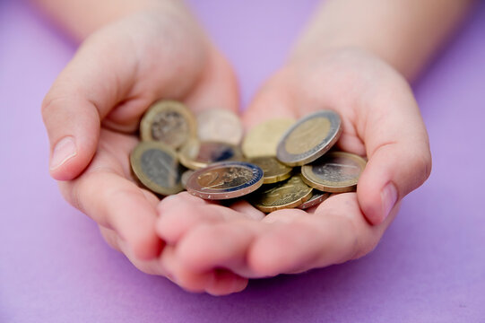 Euro Coins In Kids Hands. Currency Transfer, Investment, Payment, Donation, Gift Concept. Saving Money For The Future, Education, Car, Weddings.