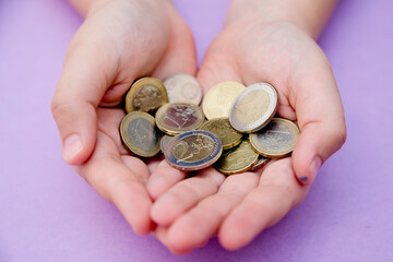 Euro coins in kids hands. Currency transfer, investment, payment, donation, gift concept. Saving money for the future, education, car, weddings.