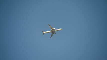 Airplane shortly after takeoff against a clear blue sky